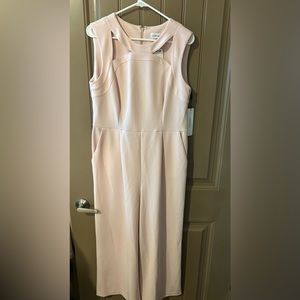 Calvin Klein NWT light peach jumpsuit! Size 12. Sleeveless with detail at neck.